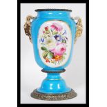 A 19th Century French ceramic urn vase in the manner of Sevres having a powder blue ground with
