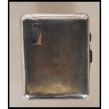 A circa 1930's Art Deco silver cigarette case of curved rectangular form having engine turned