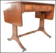 A 20th Century Georgian revival mahogany drop leaf Sofa Table, the plain top over a frieze with