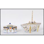 A 20th Century continental enamelled ink well in the form of a boat having two removable lidded