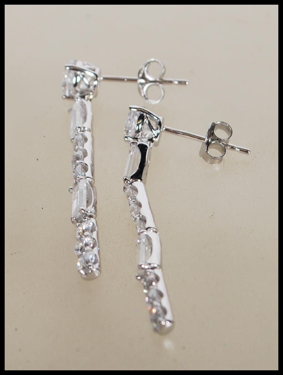 A pair of stamped 925 silver drop earrings set with Cz's. Stamped 925 to verso. Measure 1.5 inches - Image 2 of 4