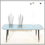 A retro vintage mid 20th Century atomic coffee table with a vivid blue top raised on splayed