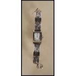 A vintage Pulsar water resistant ladies wrist watch having a rectangular face with white enamelled