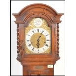 An early 20th Century Edwardian Jacobean revival panel oak cased grandmother clock. The trunk with