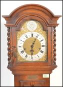 An early 20th Century Edwardian Jacobean revival panel oak cased grandmother clock. The trunk with