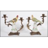 A pair of 20th Century Continental barss and the ceramic candlesticks. The centers having ceramic
