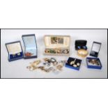 A collection of vintage costume jewellery to include a selection of gold plated cufflinks, a faux