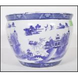 A 20th Century Chinese blue and white planter pot having transfer printed landscape scene