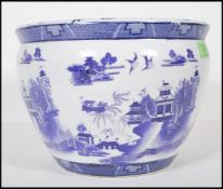 A 20th Century Chinese blue and white planter pot having transfer printed landscape scene