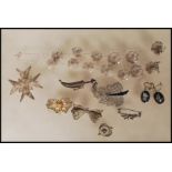 A collection of silver white metal filigree jewellery to include a dagger brooch, butterfly