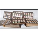 A collection of cigarette cards dating from the early 20th Century contained within four London