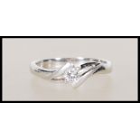 A stamped 18ct white gold solitaire diamond ring set to a decorative mount. Approx 15pts. Stamped