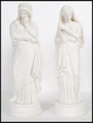 A pair of 20th Century ceramic blanc de chine classical figurines of two of the Greek muses,