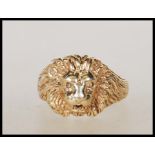 An English hallmarked 9ct gold lion mask ring having pierced eyes and mouth. Assay marks for London.