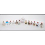 A collection of 14 assorted Chinese perfume bottles, each with a different design to each to include