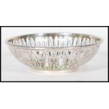 An English hallmarked trinket bowl having pierced decoration to the sides and garland decoration