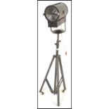 A 20th Century vintage stage /  film / theatre spotlight of tubular form raised on a extendable