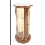 A good 20th Century mahogany cylinder bijouterie table / counter top display cabinet, single full