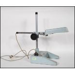 A retro mid 20th Century Stereoramic metal tabletop magnifier having adjustable stem with inbuilt