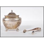 A silver hallmarked sugar pot having a twist decorated finial atop the hinged lid opening to