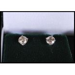 A pair of white gold and diamond single stone round cut stud earrings of approx 80 pts. Gross weight