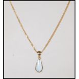 A stamped 375 9ct gold necklace chain having a drop shaped opal pendant on a gold bale. Weight 5.3g.