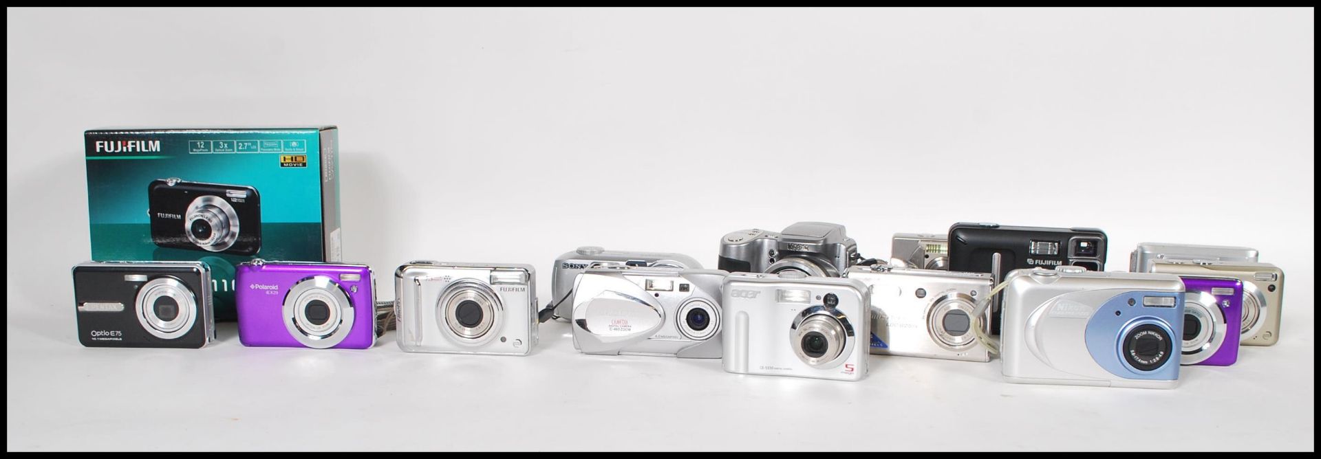 A collection of digital cameras to include makes from Fuji, Lumicorn, Premier, Konica, Polaroid,