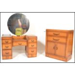An early 20th Century Art Deco oak kneehole twin pedestal dressing table, circular mirror to top