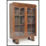 A first half of the 20th Century oak twin glazed door china display cabinet adjustable shelves to