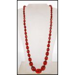 A cherry bakelite necklace having fiftyfive gradua