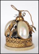 A turn of the Century high Victorian evening dinner bell having three mother of pearl shells with