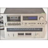 A part Pioneer stacking system having stereo tuner model TX-606 and stereo cassette tape deck CT-