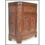 An early 20th Century Chinese hardwood carved metamorphic cocktail cabinet, having carved relief