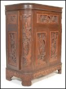 An early 20th Century Chinese hardwood carved metamorphic cocktail cabinet, having carved relief