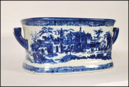 A large 20th Century reproduction stoneware blue and white Victorian style printed twin handled