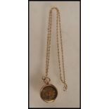 A stamped 14ct gold pocket fob watch having a gilt dial with scrolled foliate detailing with roman