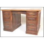An early to mid 20th Century oak partners twin pedestal desk. Raised on twin pedestals with large