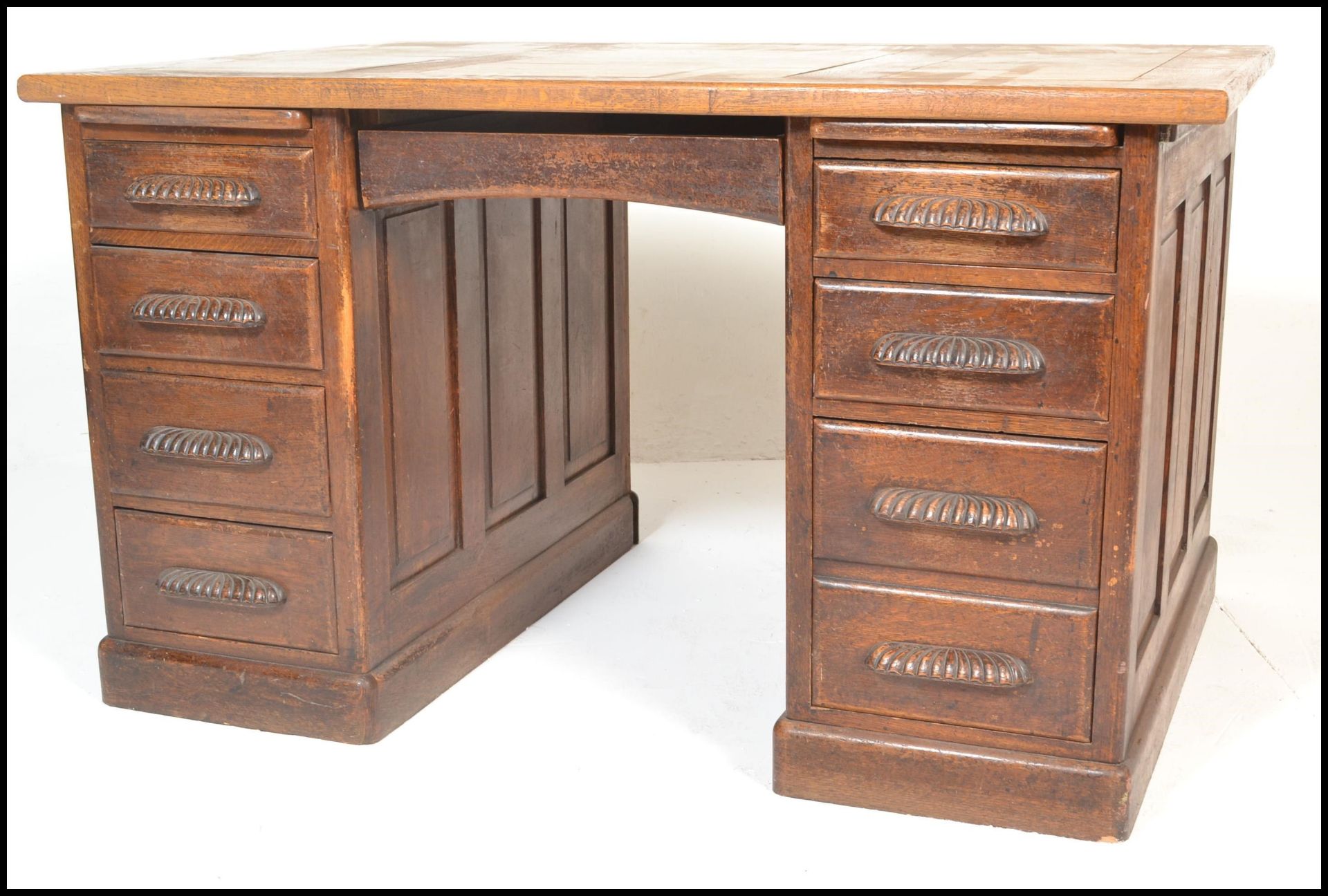 An early to mid 20th Century oak partners twin pedestal desk. Raised on twin pedestals with large