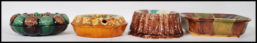A group of four 19th Century Victorian majolica spittoon's one marked Bailey pottery with moulded