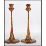 A pair of late 19th / early 20th Century Arts and Crafts poker work candlesticks raised on round