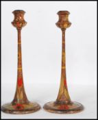 A pair of late 19th / early 20th Century Arts and Crafts poker work candlesticks raised on round