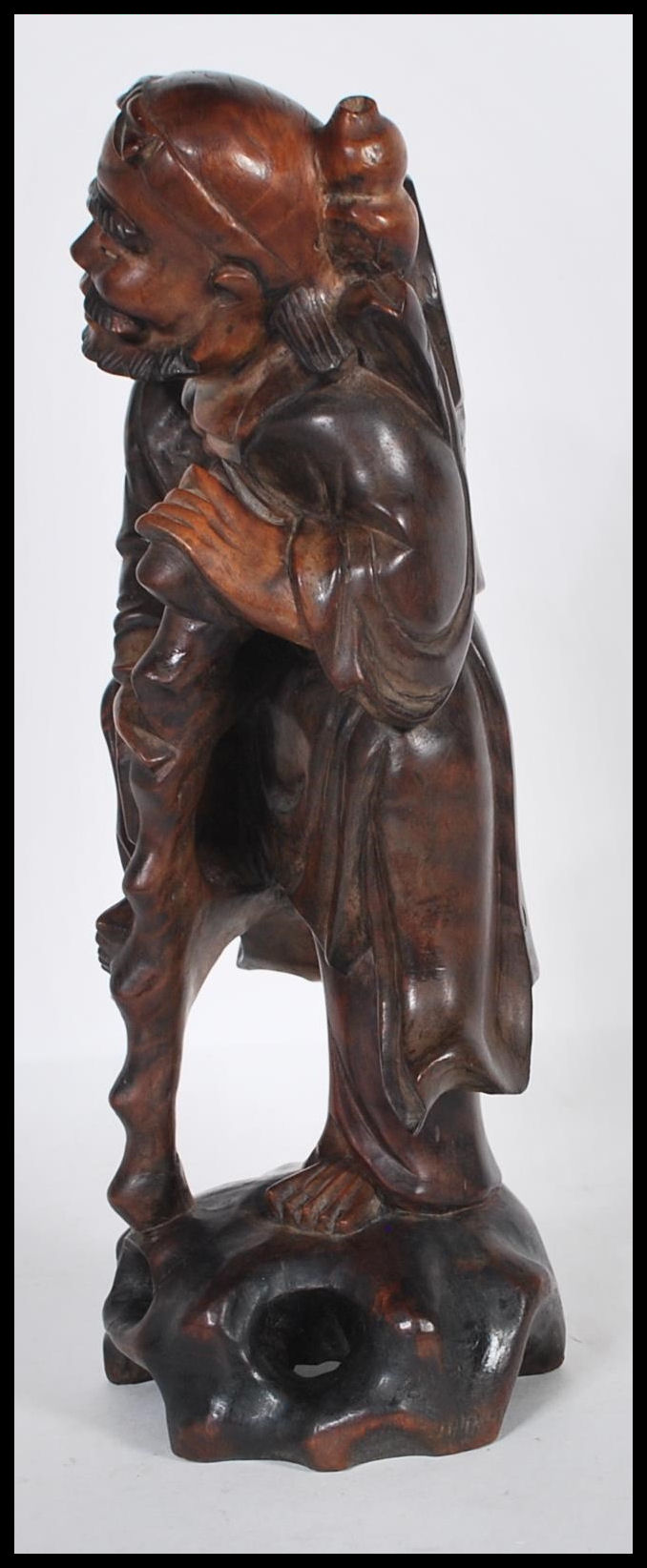 An early 20th Century Chinese carved hardwood figure of an Immortal holding a gnarled staff with one - Image 4 of 6