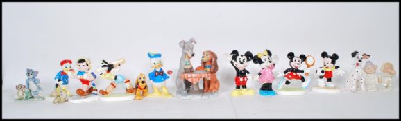 A group of vintage ceramic Disney figurines including a selection of Mickey and Minnie figures,