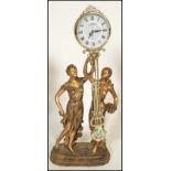 A contemporary Juliana figural pendulum quartz clock, the movement held aloft by two classical style