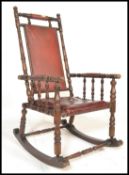 A Regency style rocking chair with open framework upholstered in a maroon coloured buttoned