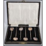 A boxed set of six 1930's art deco vintage solid silver hallmarked coffee bean spoons with coffee