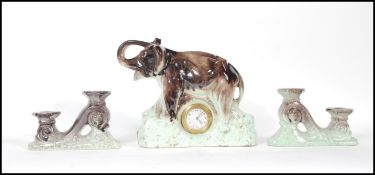 A early 20th Century Art Deco 1930's French 3 piece ceramic clock garniture set. The clock itself in