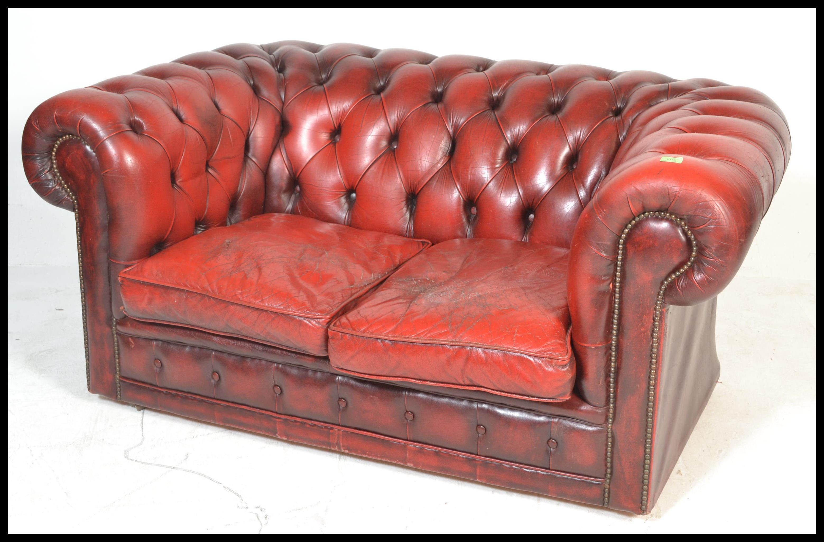 A 20th Century Oxblood leather upholstered chesterfield two seater sofa, having buttoned rounded - Image 2 of 4