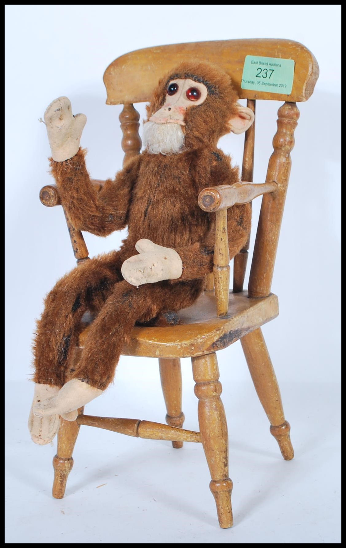 A vintage 1950's Merrythought made soft toy straw filled monkey with bead eyes and original label