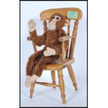 A vintage 1950's Merrythought made soft toy straw filled monkey with bead eyes and original label